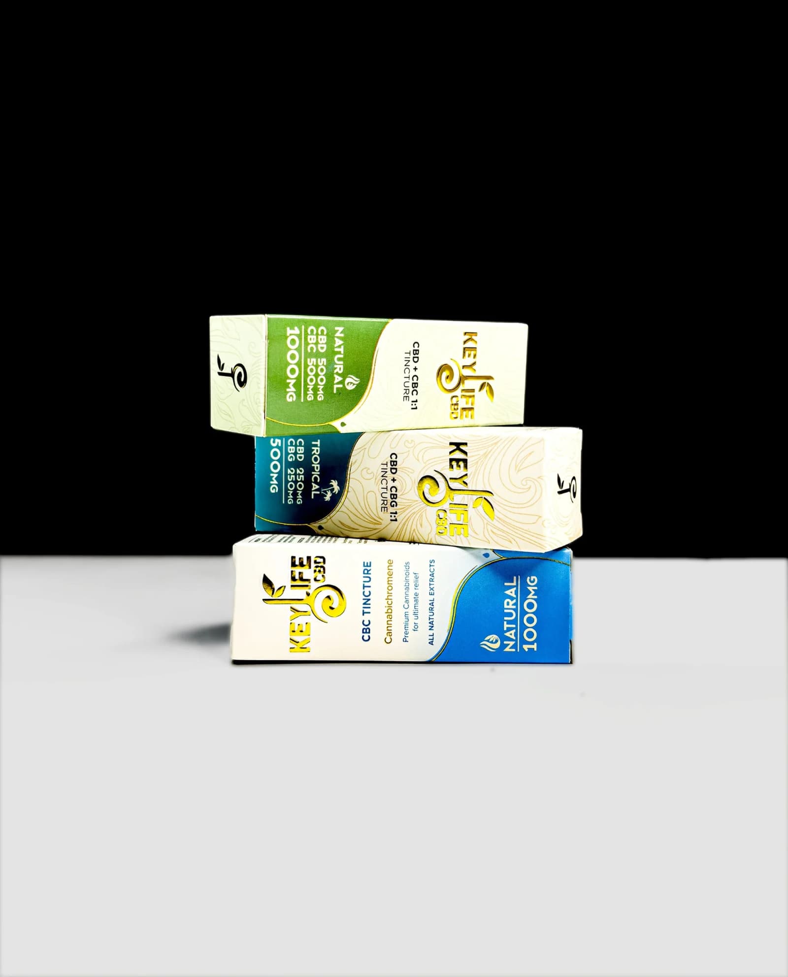 Custom CBD tincture boxes with gold foil branding, stacked